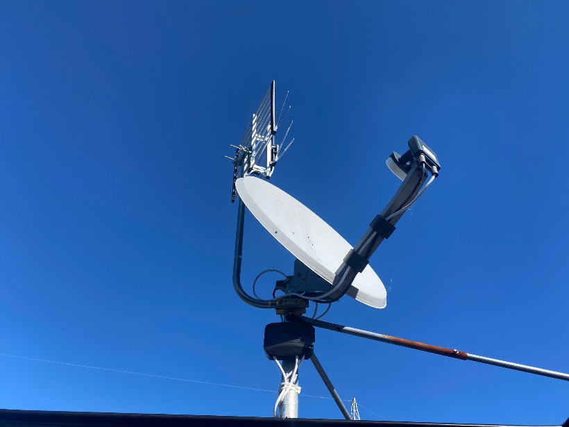 Combined satellite dish and UHF aerial mounted on a mast